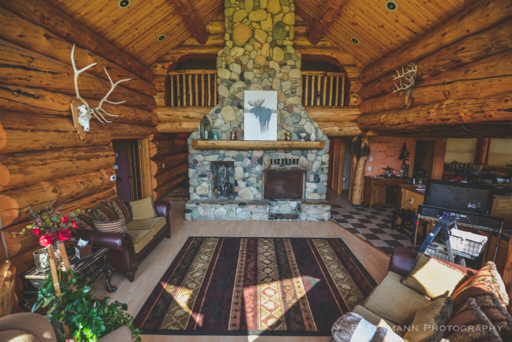 Great room with stone fireplace and lodge seating