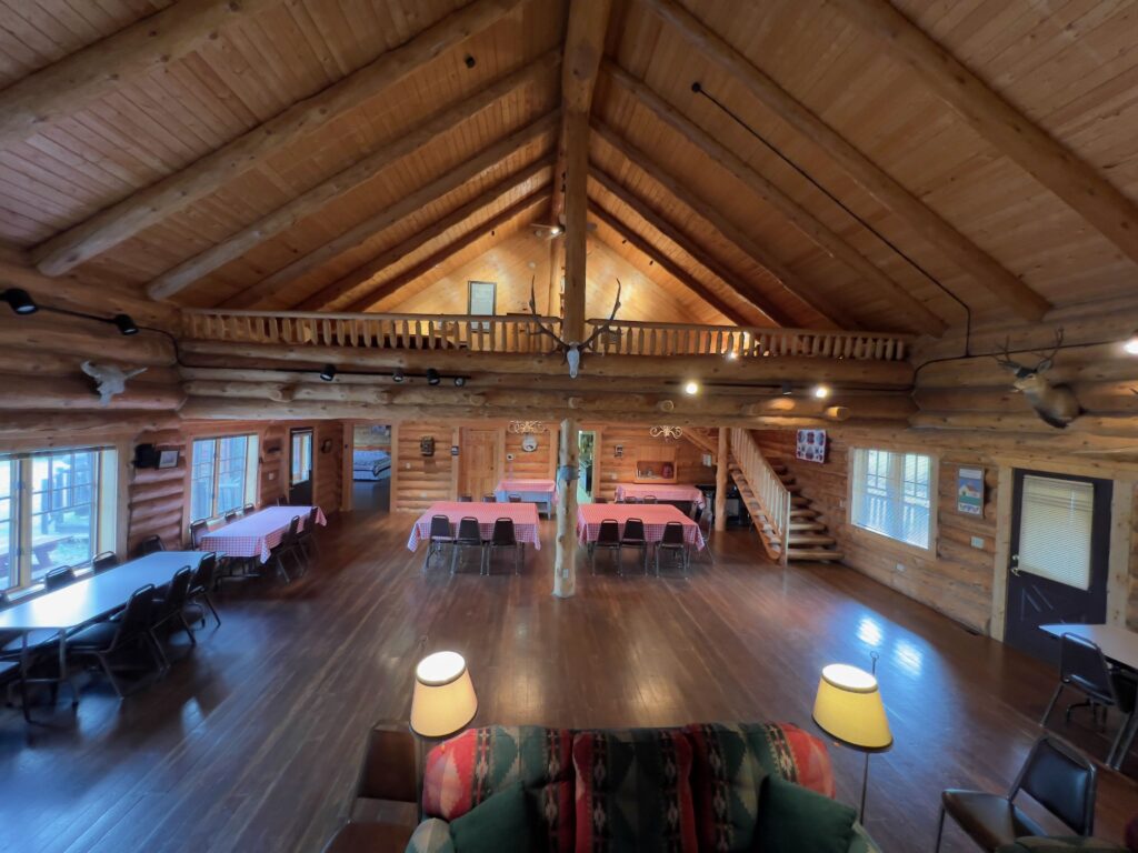 Great room and loft with log railings overlooking the main floor