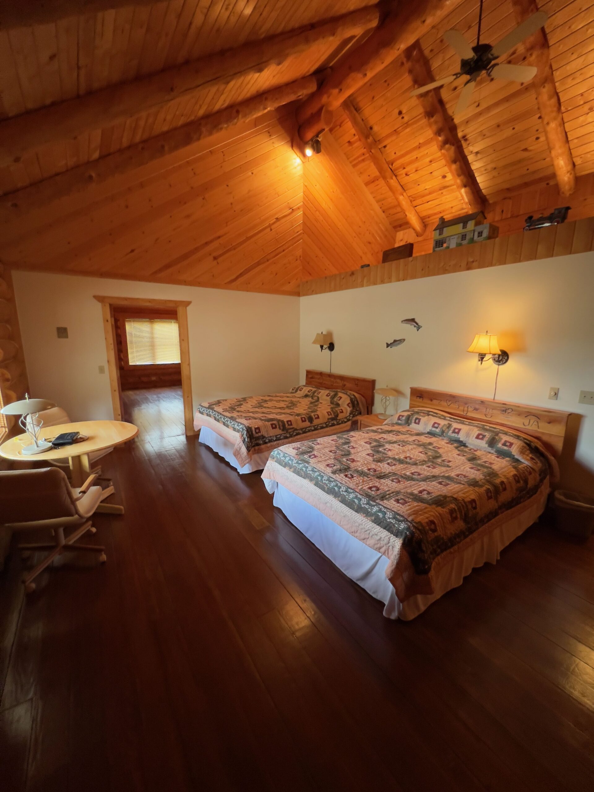 Double queen guest room with log construction and lodge furnishings