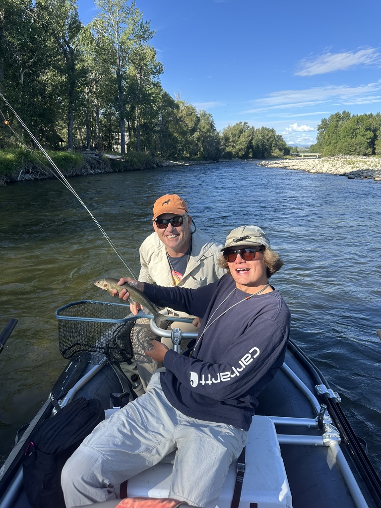 Couple with a catch in the drift boat