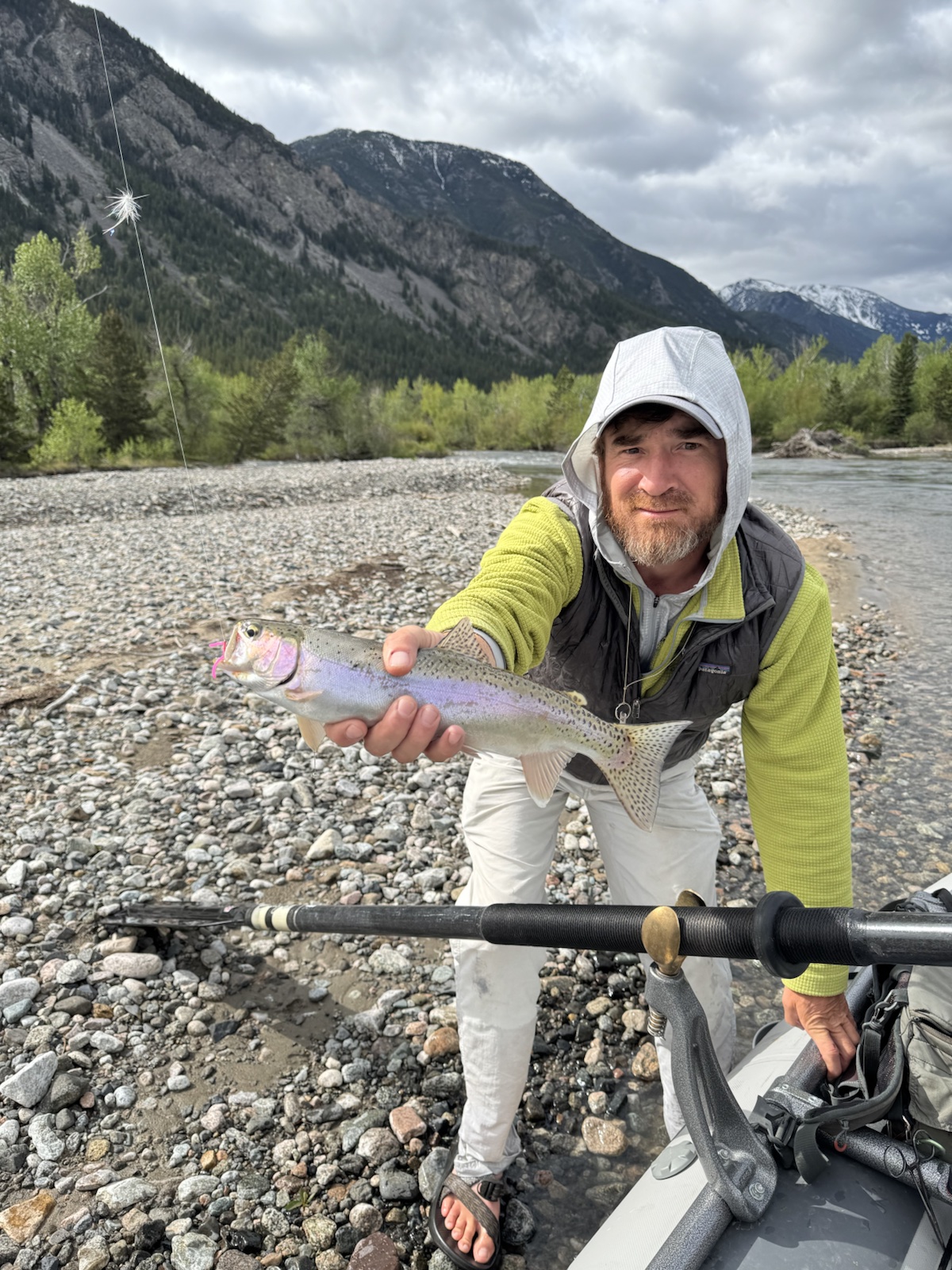 Guide Neal Mitchell with a rainbow trout on a Montana gravel bar