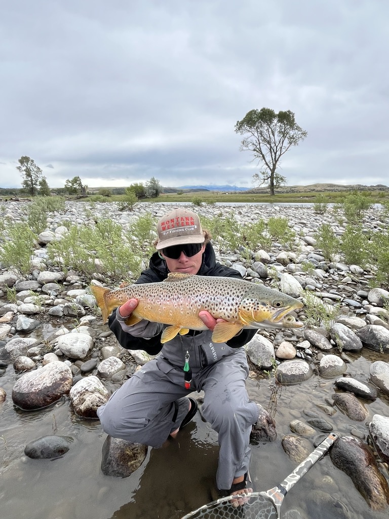 Guide Keenan Morrison releasing a brown trout