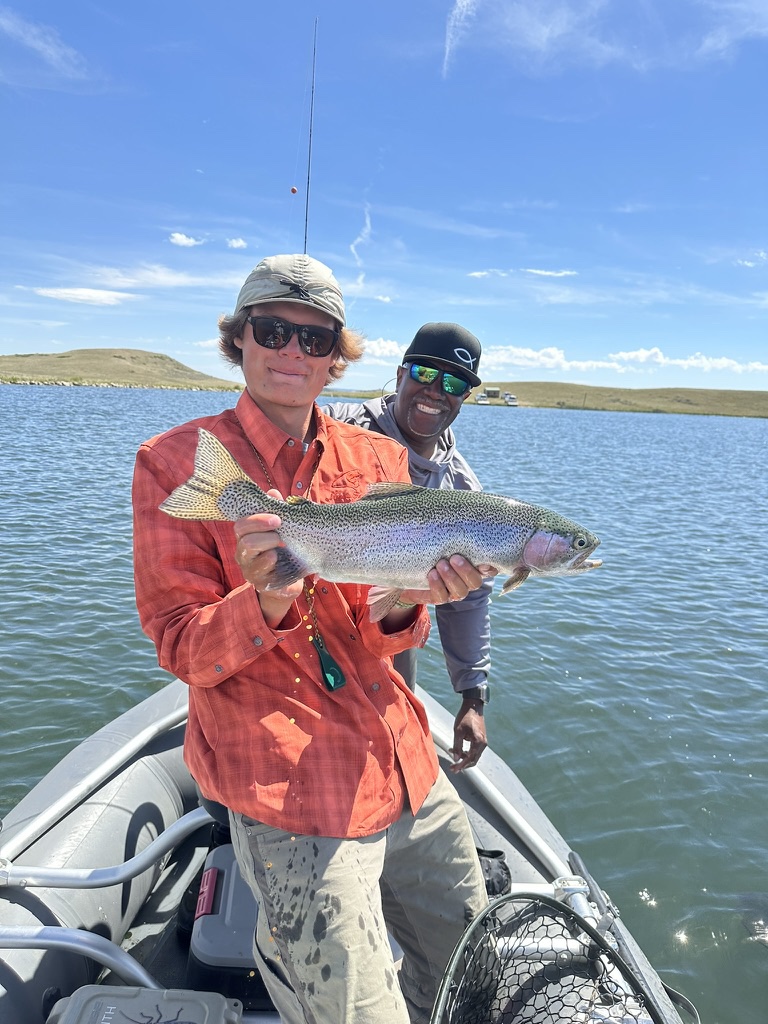 Guide Chase Glowacki with a guest and a rainbow trout