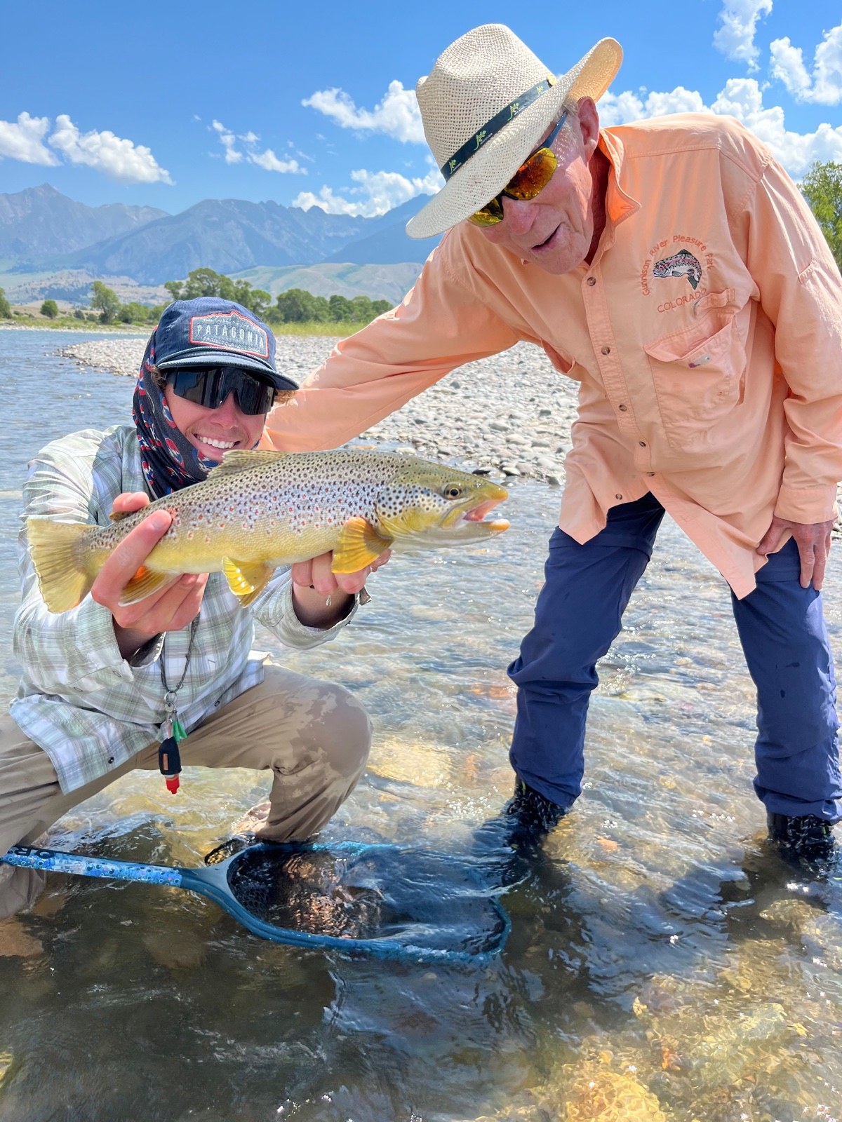 Guide Keenan Morrison with a guest and a brown trout