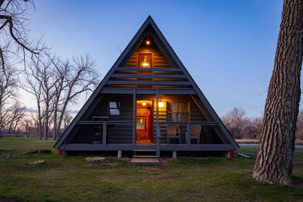 A-frame guest cabin lit at dusk