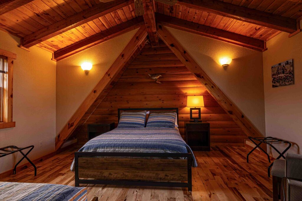 Guest bedroom with vaulted log ceiling