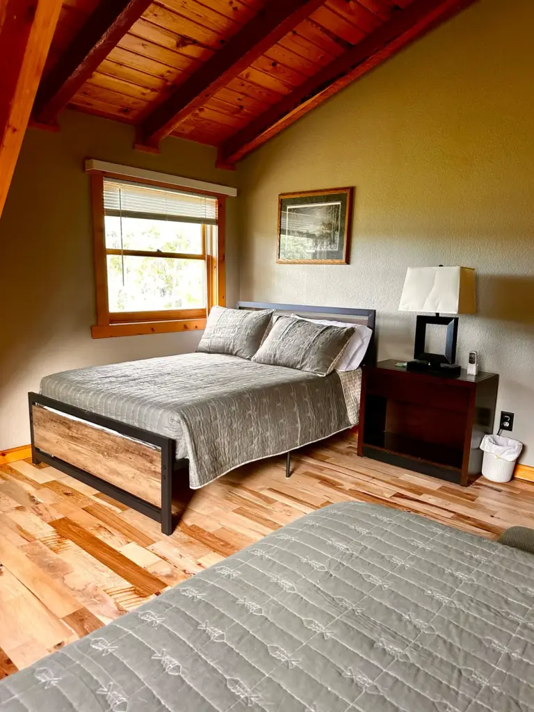 Two-queen guest room with log walls
