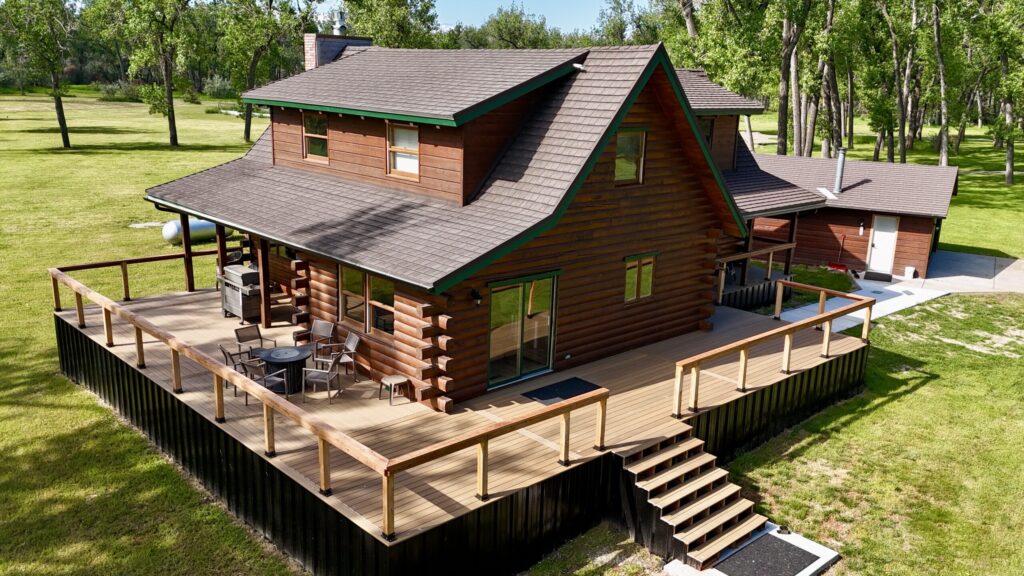 Wraparound deck with seating and fire pit at Bighorn River Fly Fishing Lodge